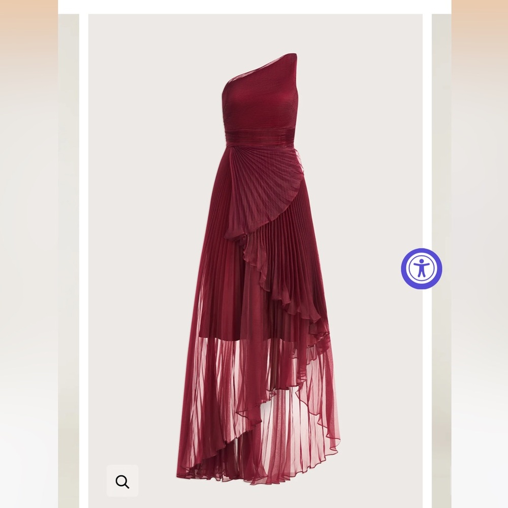 pleated gown is crafted of organza material with one shoulder neckline